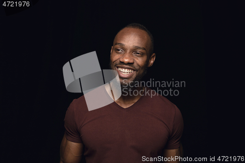 Image of Close up portrait of young man isolated on black studio background