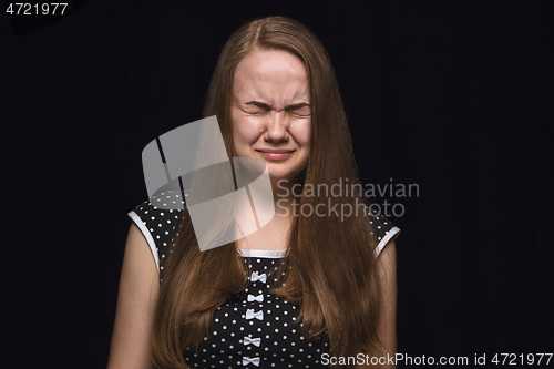 Image of Close up portrait of young woman isolated on black studio background