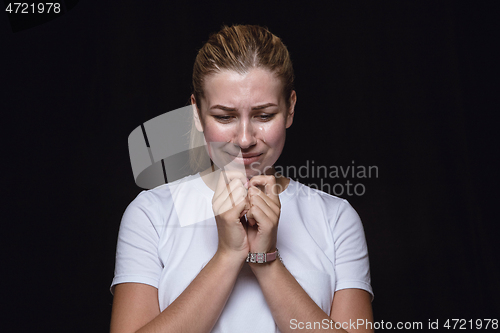 Image of Close up portrait of young woman isolated on black studio background