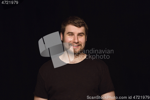 Image of Close up portrait of young man isolated on black studio background