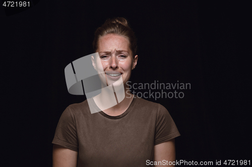 Image of Close up portrait of young woman isolated on black studio background