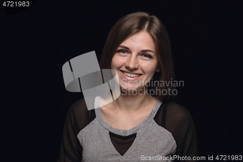 Image of Close up portrait of young woman isolated on black studio background