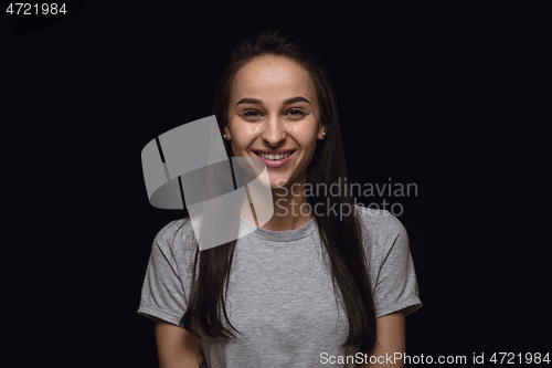 Image of Close up portrait of young woman isolated on black studio background