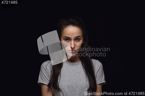 Image of Close up portrait of young woman isolated on black studio background