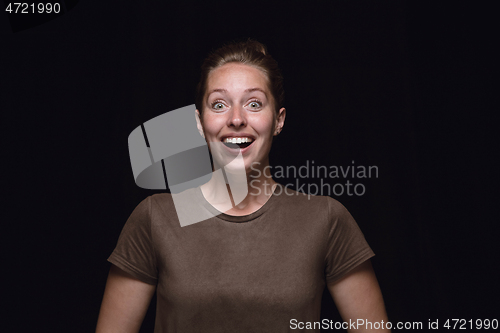 Image of Close up portrait of young woman isolated on black studio background