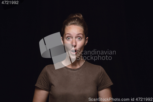 Image of Close up portrait of young woman isolated on black studio background