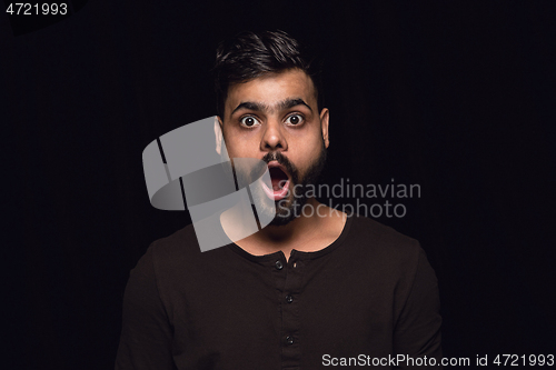 Image of Close up portrait of young man isolated on black studio background