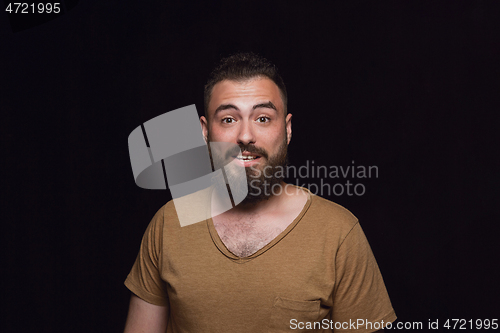 Image of Close up portrait of young man isolated on black studio background