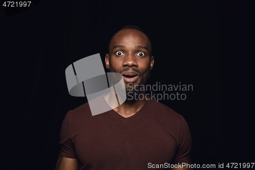 Image of Close up portrait of young man isolated on black studio background