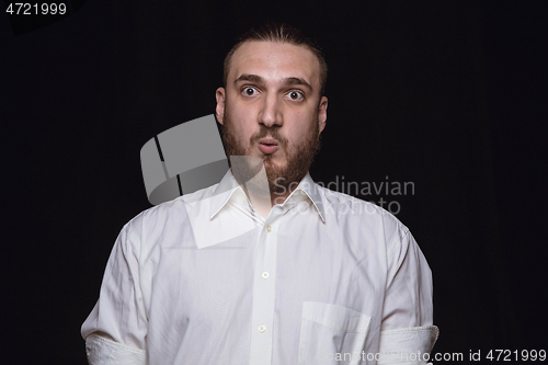 Image of Close up portrait of young man isolated on black studio background