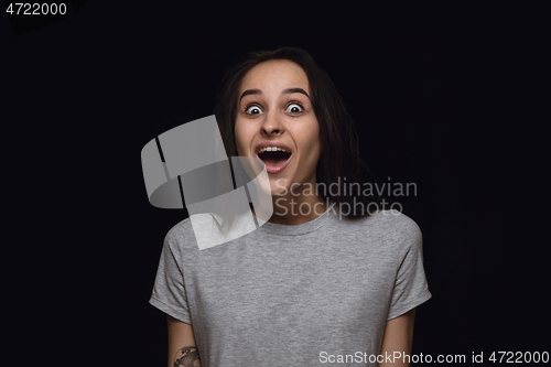 Image of Close up portrait of young woman isolated on black studio background