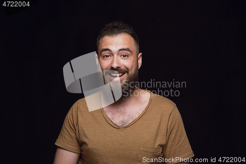 Image of Close up portrait of young man isolated on black studio background