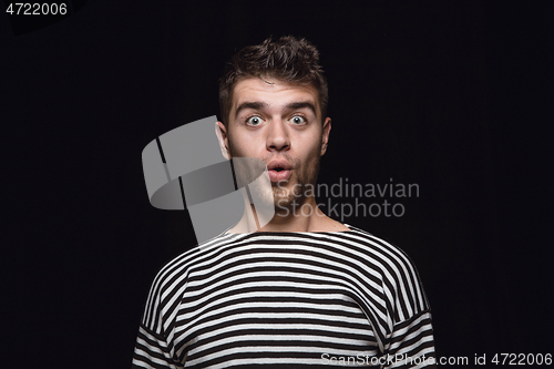 Image of Close up portrait of young man isolated on black studio background