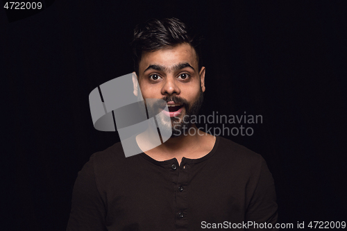 Image of Close up portrait of young man isolated on black studio background