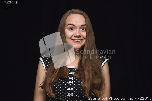 Image of Close up portrait of young woman isolated on black studio background