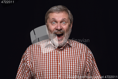 Image of Close up portrait of senior man isolated on black studio background