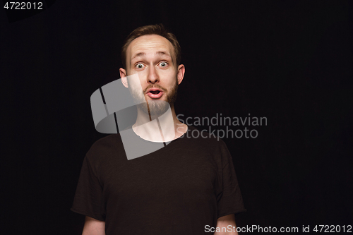 Image of Close up portrait of young man isolated on black studio background