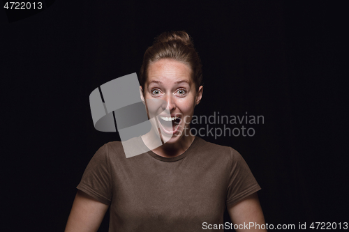 Image of Close up portrait of young woman isolated on black studio background