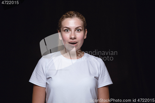 Image of Close up portrait of young woman isolated on black studio background