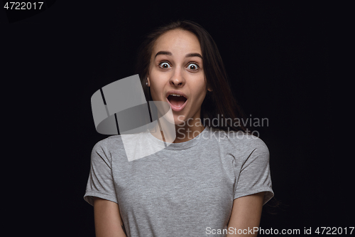 Image of Close up portrait of young woman isolated on black studio background