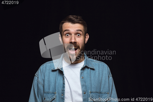 Image of Close up portrait of young man isolated on black studio background