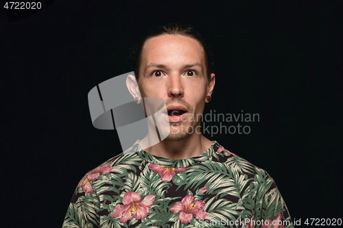 Image of Close up portrait of young man isolated on black studio background