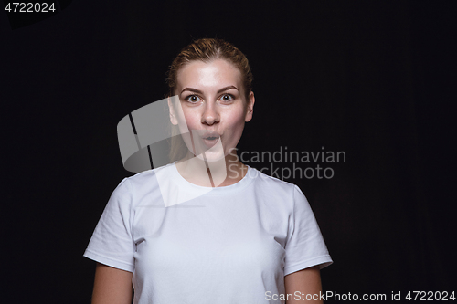 Image of Close up portrait of young woman isolated on black studio background