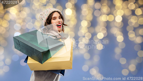 Image of woman in hat with shopping bags on christmas