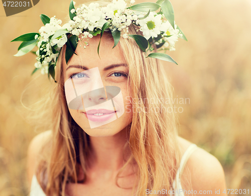 Image of happy woman in wreath of flowers