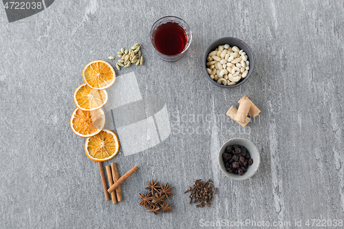 Image of hot mulled wine, orange slices, raisins and spices