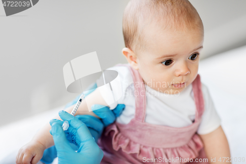 Image of doctor making vaccine for baby patient at clinic