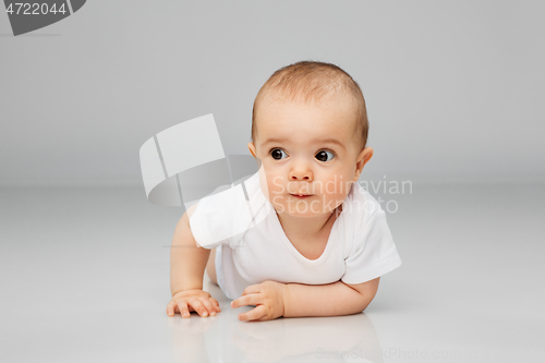 Image of sweet little baby lying on floor