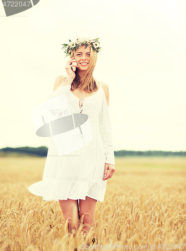 Image of happy young woman calling on smartphone at country