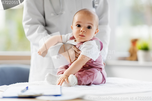 Image of female pediatrician doctor with baby at clinic