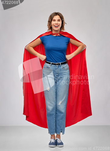 Image of happy woman in red superhero cape
