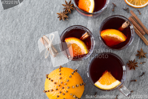 Image of hot mulled wine, orange slices, raisins and spices