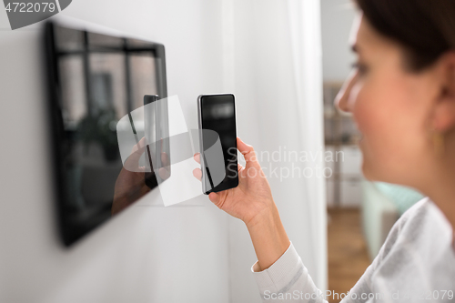 Image of woman using tablet computer and smartphone