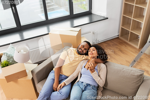 Image of happy couple with boxes moving to new home