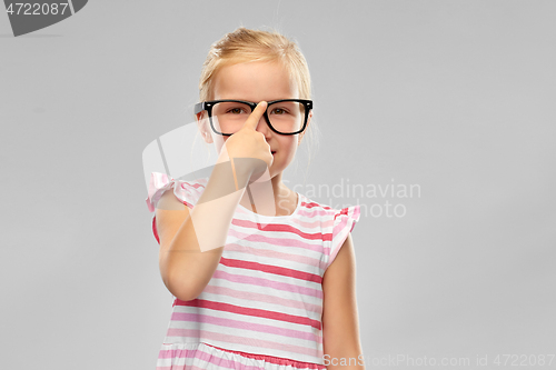 Image of smiling cute little girl in black glasses