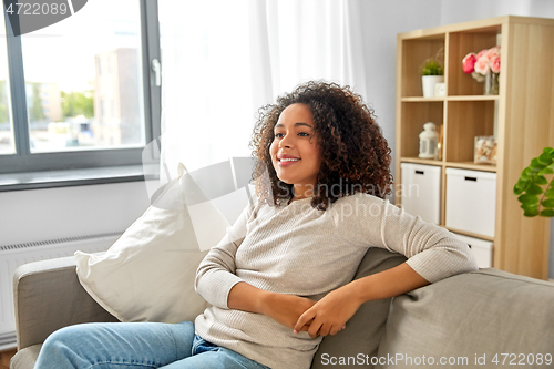 Image of happy african american young woman at home