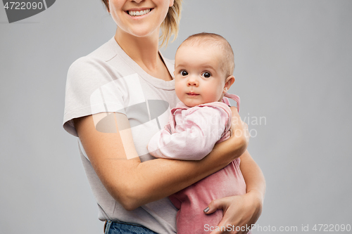 Image of happy young mother holding little baby daughter