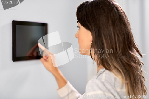 Image of woman using tablet computer at smart home