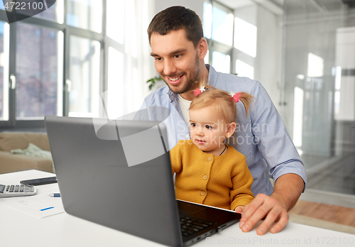 Image of working father with baby daughter at home office