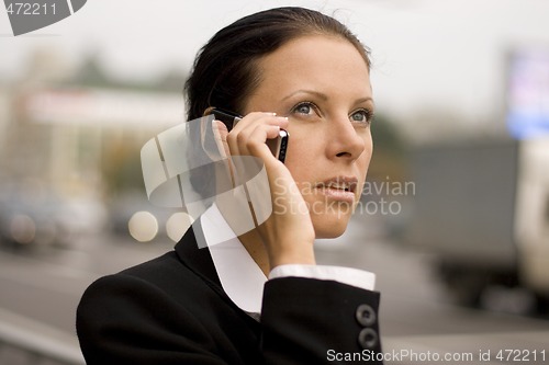 Image of businesswoman talking by mobile phone