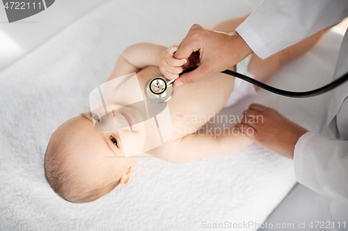 Image of doctor with stethoscope listening to baby patient