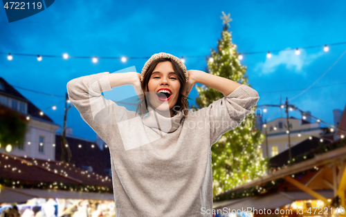 Image of woman in hat and sweater at christmas market