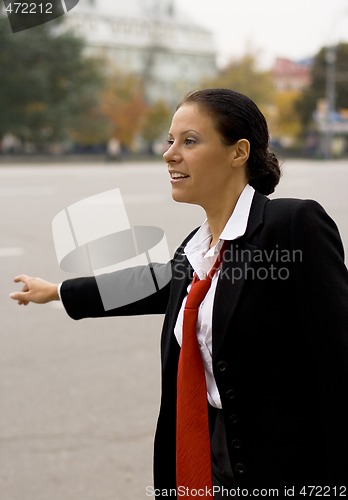 Image of hitchhiking businesswoman 