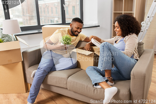 Image of happy couple with boxes moving to new home