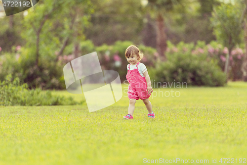 Image of little girl spending time at backyard