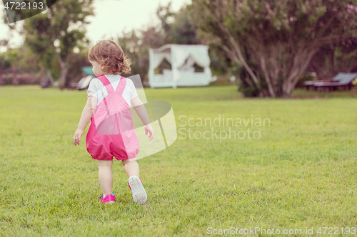 Image of little girl spending time at backyard